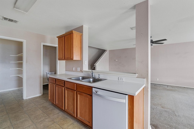 kitchen with sink, white dishwasher, ceiling fan, and light colored carpet