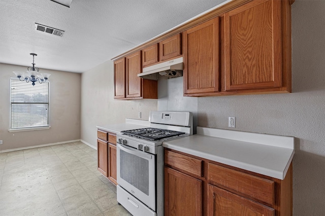 kitchen featuring white gas range oven, an inviting chandelier, and pendant lighting