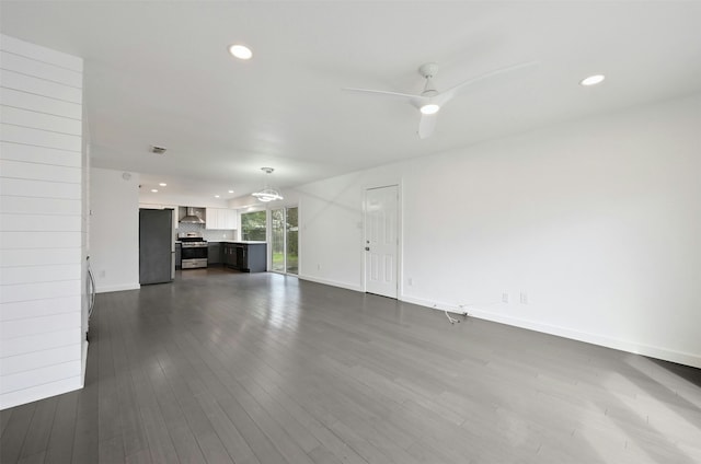 unfurnished living room with ceiling fan and dark hardwood / wood-style floors