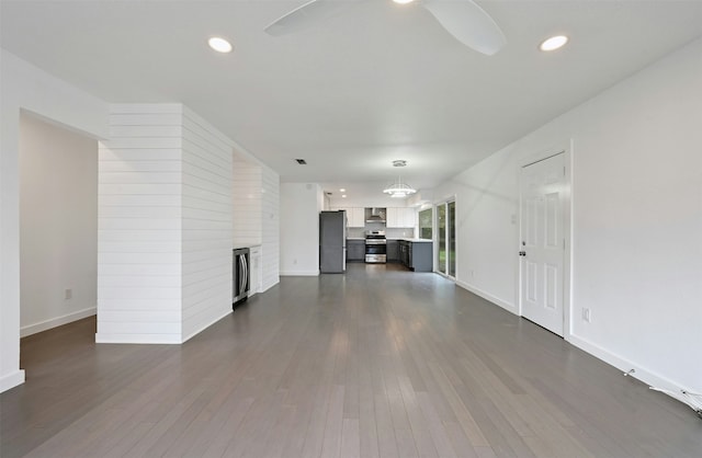 unfurnished living room featuring dark wood-type flooring and a fireplace