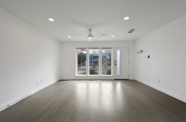 empty room with ceiling fan and dark hardwood / wood-style floors