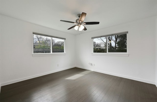 empty room with ceiling fan and dark hardwood / wood-style floors