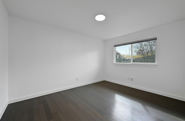 unfurnished room featuring dark hardwood / wood-style floors