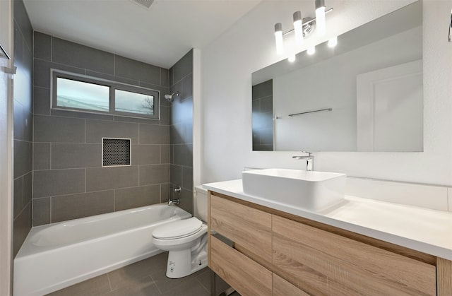 full bathroom featuring toilet, vanity, tile patterned floors, and tiled shower / bath combo