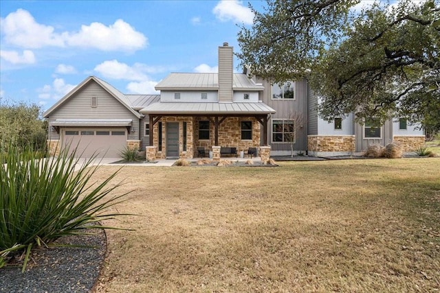 rear view of house featuring a garage, a porch, and a yard