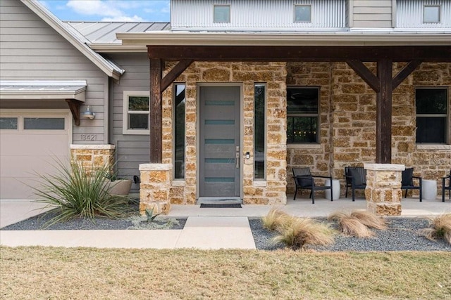 view of exterior entry featuring covered porch