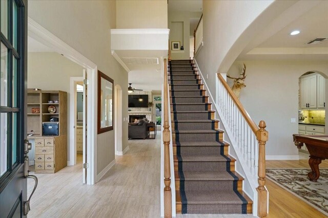 entrance foyer featuring a high ceiling, ceiling fan, and light hardwood / wood-style floors