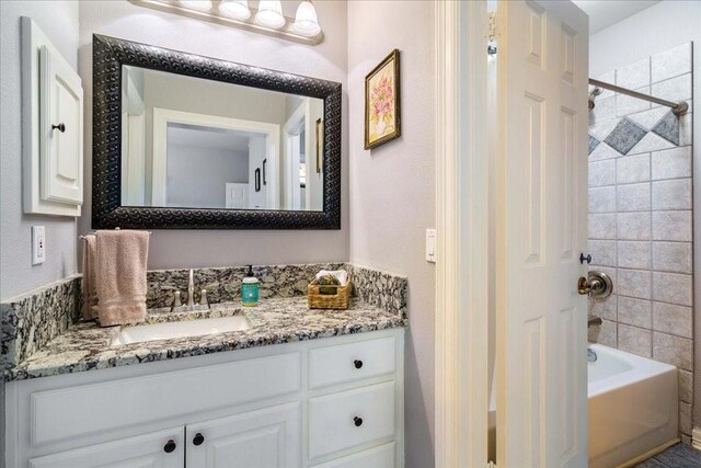 bathroom featuring vanity and tiled shower / bath combo