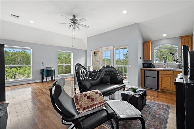 living room with wood-type flooring and ceiling fan