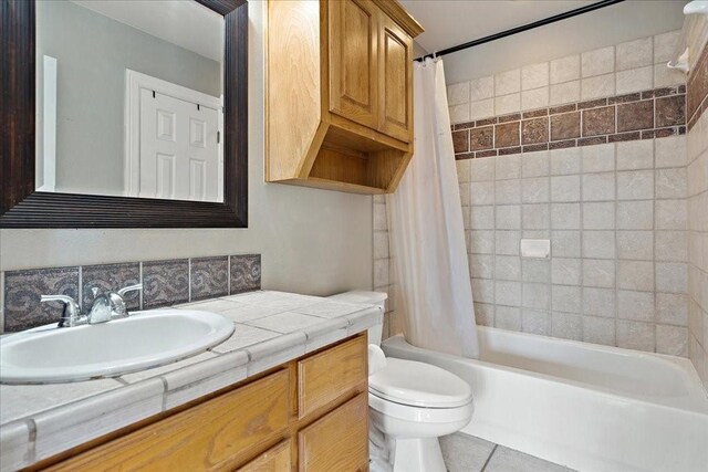 full bathroom with vanity, tile patterned flooring, toilet, and shower / tub combo with curtain