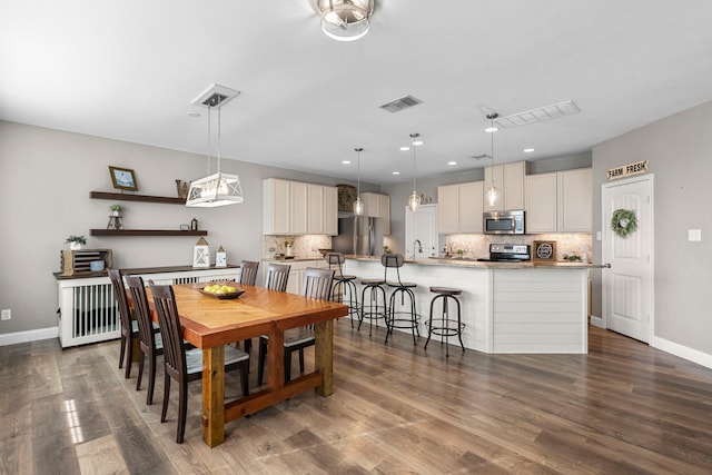 dining space with dark wood-type flooring and sink