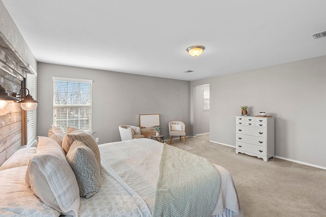 bedroom featuring light carpet and a stone fireplace