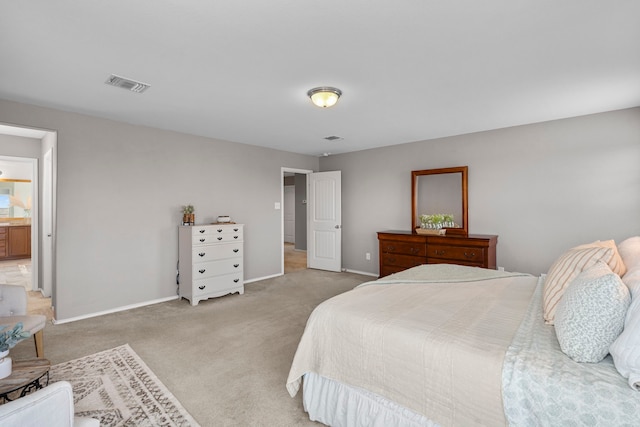 bedroom featuring carpet and ensuite bath