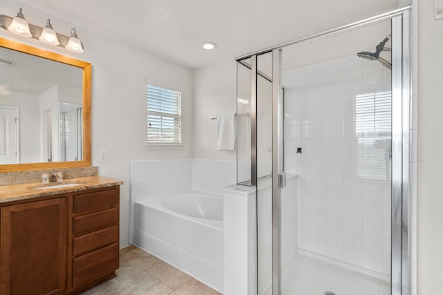 bathroom featuring plus walk in shower, tile patterned flooring, and vanity