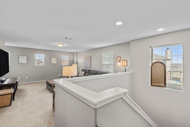 interior space featuring light carpet and plenty of natural light