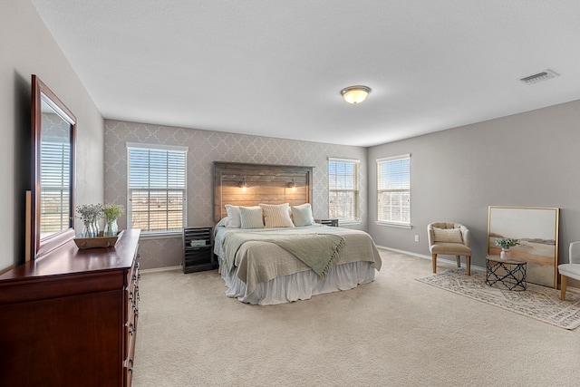 carpeted bedroom with multiple windows