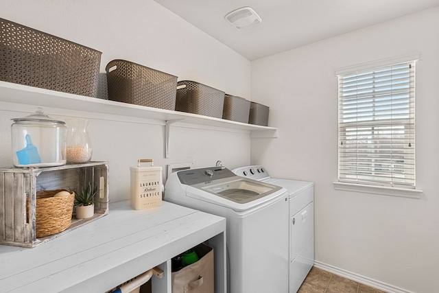 laundry room featuring light tile patterned flooring and washer and dryer