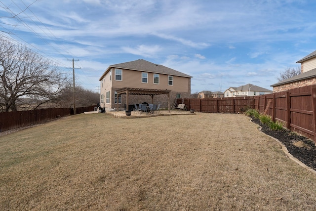 rear view of house with a pergola, a patio area, and a lawn