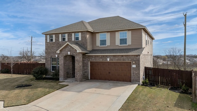 view of front of home featuring a front yard and a garage