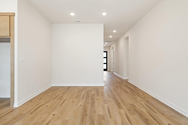 empty room with light hardwood / wood-style flooring