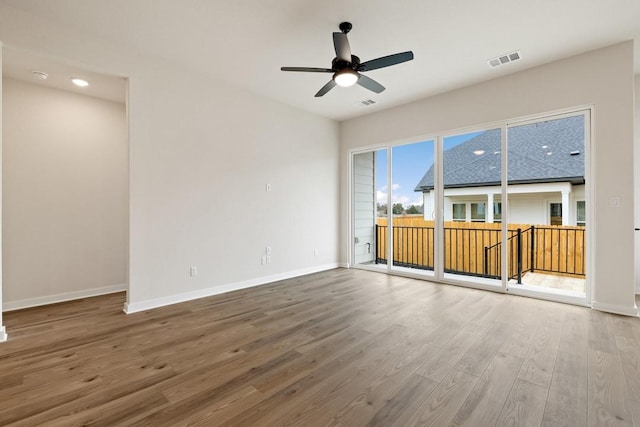 unfurnished living room with ceiling fan and hardwood / wood-style floors