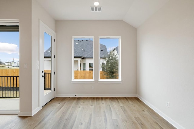 interior space featuring vaulted ceiling and light hardwood / wood-style floors