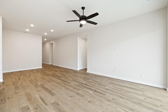 empty room with ceiling fan and light hardwood / wood-style floors