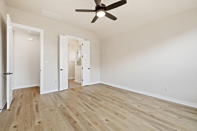 unfurnished bedroom featuring vaulted ceiling, light wood-type flooring, and ceiling fan