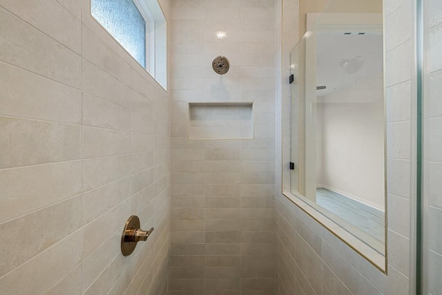 bathroom with a tile shower