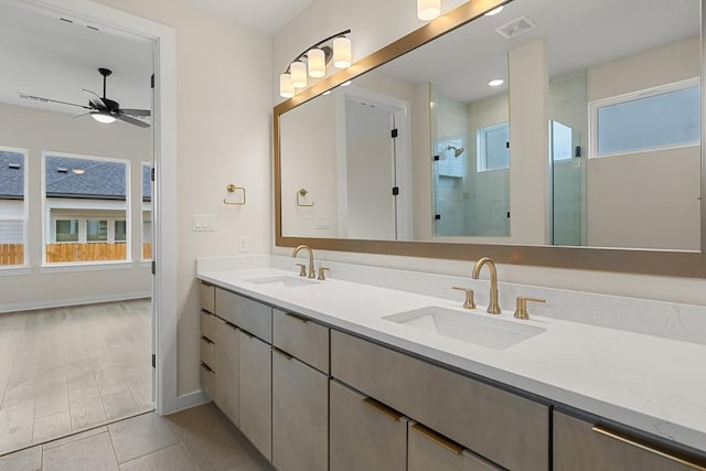 bathroom featuring ceiling fan, walk in shower, vanity, and plenty of natural light