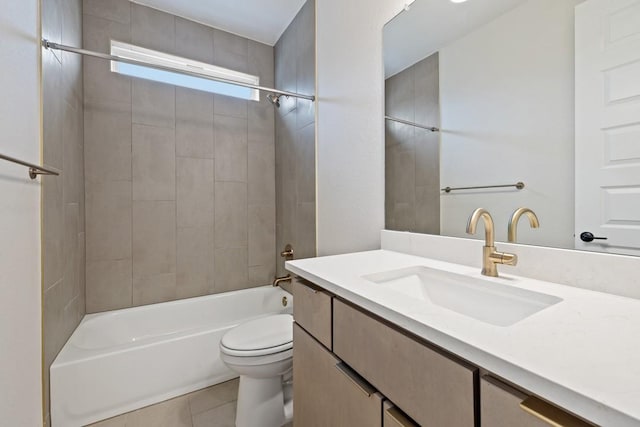 full bathroom featuring toilet, vanity, tile patterned floors, and tiled shower / bath