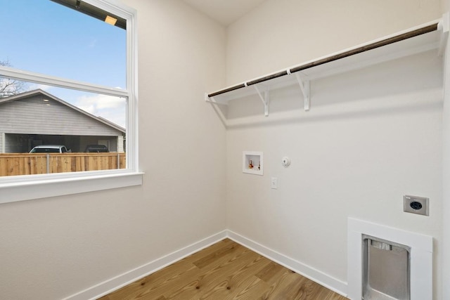 washroom featuring hookup for a washing machine, hookup for a gas dryer, electric dryer hookup, and wood-type flooring