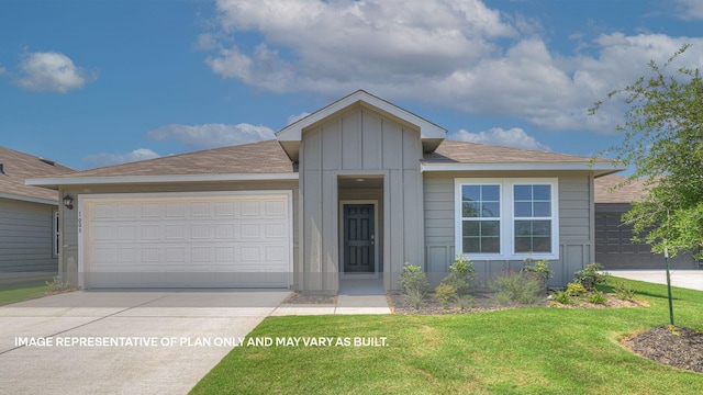 view of front of house with a front yard and a garage