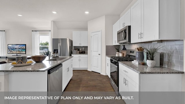 kitchen with a center island with sink, white cabinetry, dark wood-type flooring, and appliances with stainless steel finishes