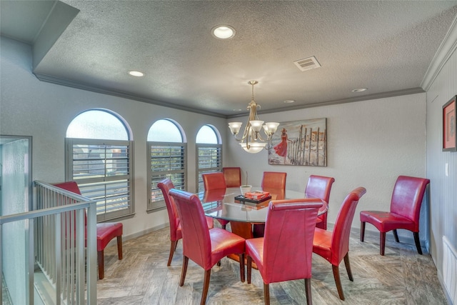 dining area featuring an inviting chandelier, parquet floors, a textured ceiling, and ornamental molding