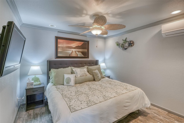 bedroom featuring a wall mounted air conditioner, hardwood / wood-style floors, ceiling fan, and crown molding