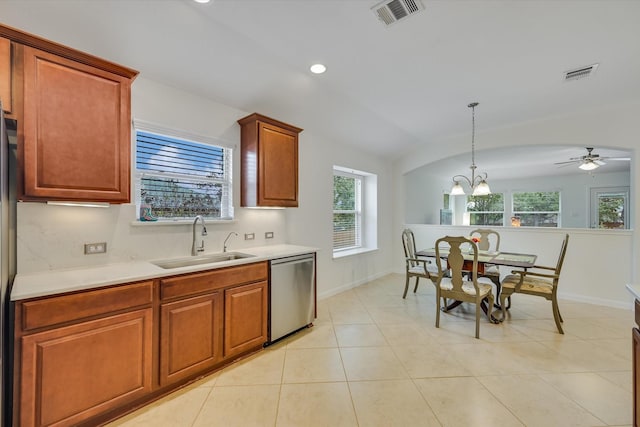 kitchen with decorative light fixtures, lofted ceiling, stainless steel dishwasher, sink, and ceiling fan with notable chandelier