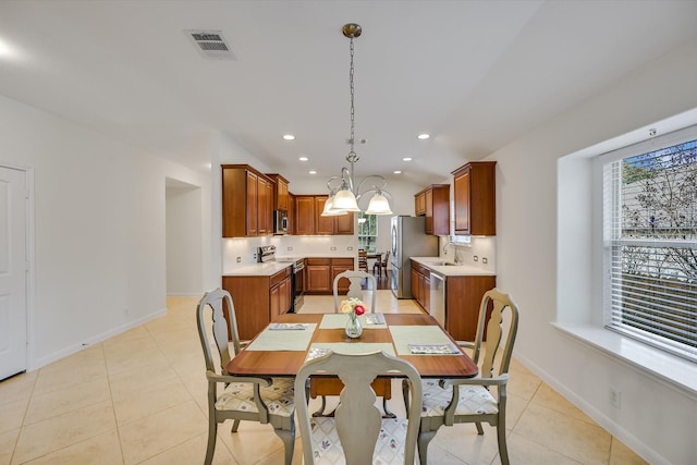 dining room with light tile patterned floors and sink