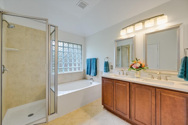 bathroom featuring vanity, tile patterned floors, and plus walk in shower