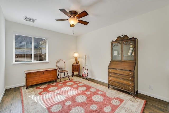 sitting room featuring ceiling fan and dark hardwood / wood-style flooring