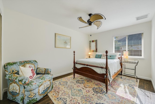 bedroom with ceiling fan and dark hardwood / wood-style flooring