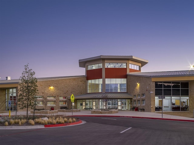 view of outdoor building at dusk