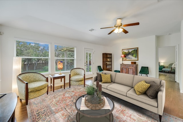 living room with ceiling fan and wood-type flooring