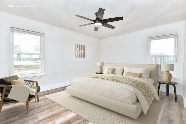 bedroom with hardwood / wood-style floors and ceiling fan