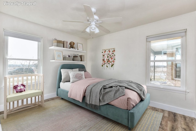 bedroom with ceiling fan and wood-type flooring