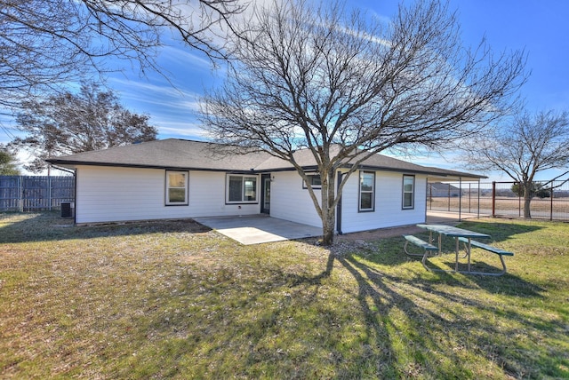 rear view of property featuring central AC, a patio area, and a yard