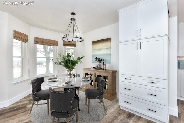 dining area with a wealth of natural light and dark hardwood / wood-style floors