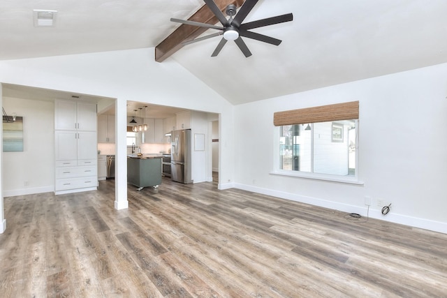 unfurnished living room featuring high vaulted ceiling, hardwood / wood-style floors, ceiling fan, and beam ceiling