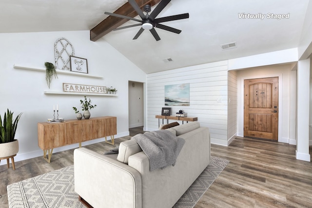 living room featuring ceiling fan, wooden walls, vaulted ceiling with beams, and hardwood / wood-style floors