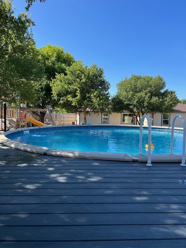 view of pool with a playground